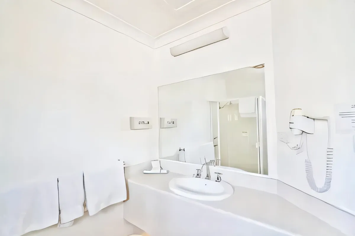 Ensuite bathroom with a wide vanity, mirror and hairdryer